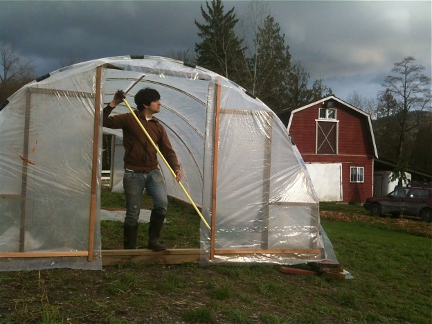 Chris confirms some measurements as we get ready to build the doors for our new polytunnel.