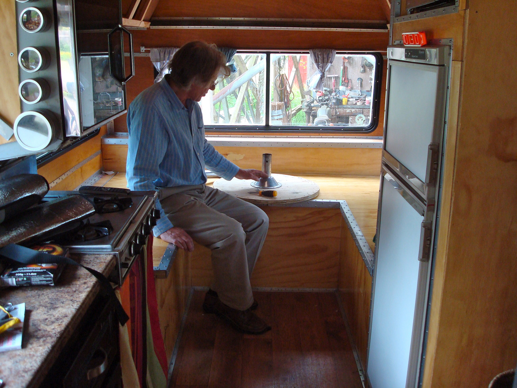 I enlisted the help of all of my very supportive family members to help clean it and work on some interior construction and decorating projects. Here's my dad figuring out how to install a larger table than the small circle table it came with.